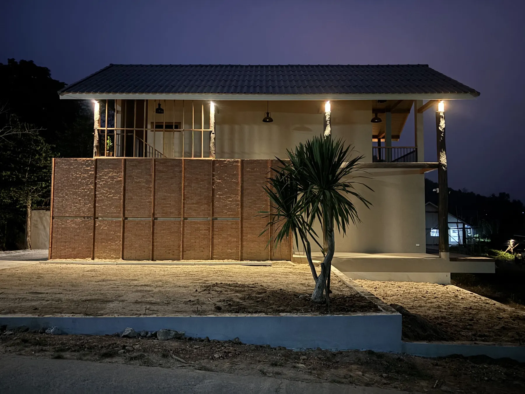 A bungalow lit up at night